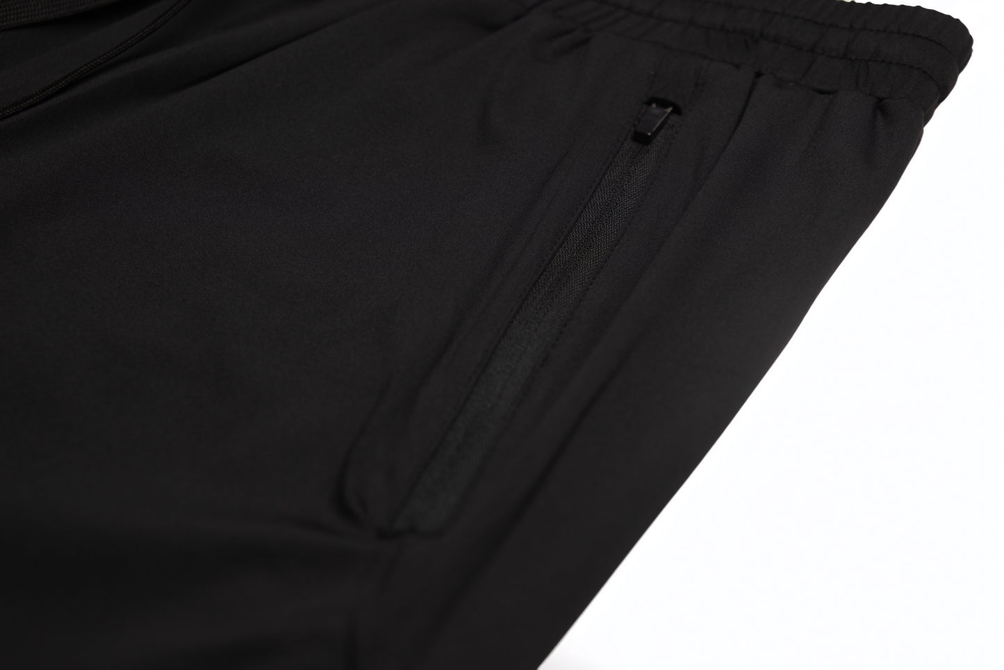 Close-up of the zippered side pocket on the Fitra Core Short in black