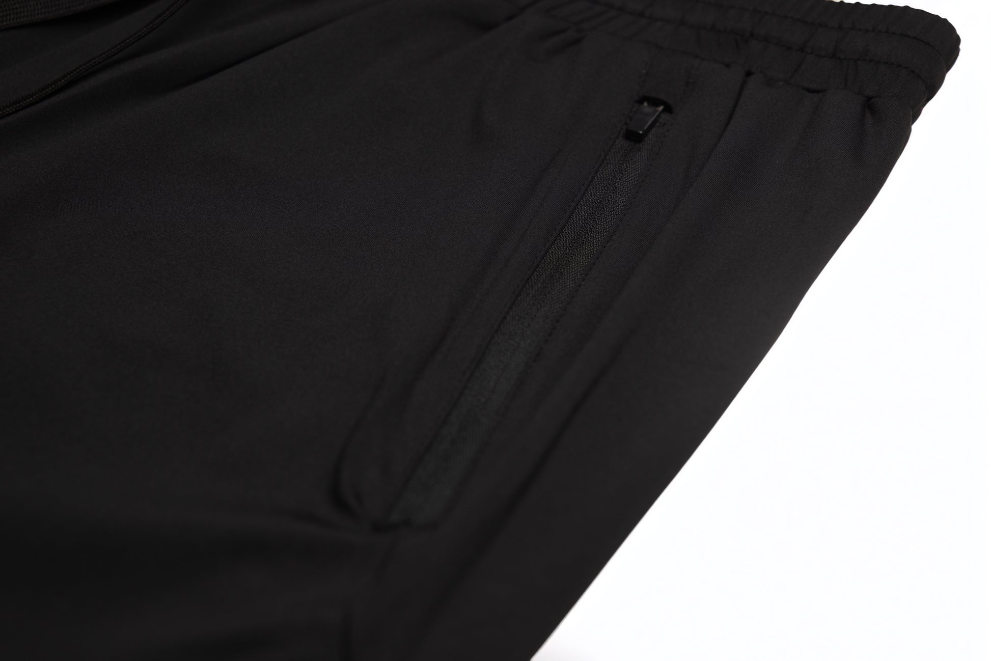 Close-up of the zippered side pocket on the Fitra Core Short in black