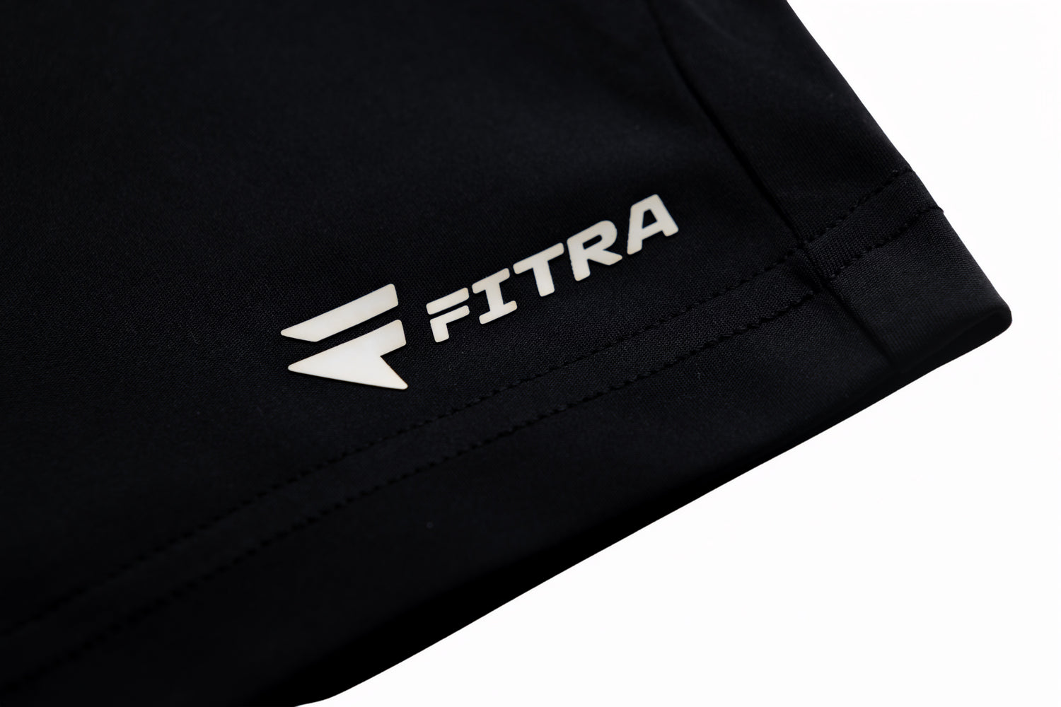 White Fitra logo printed on the hem of the black Core Short