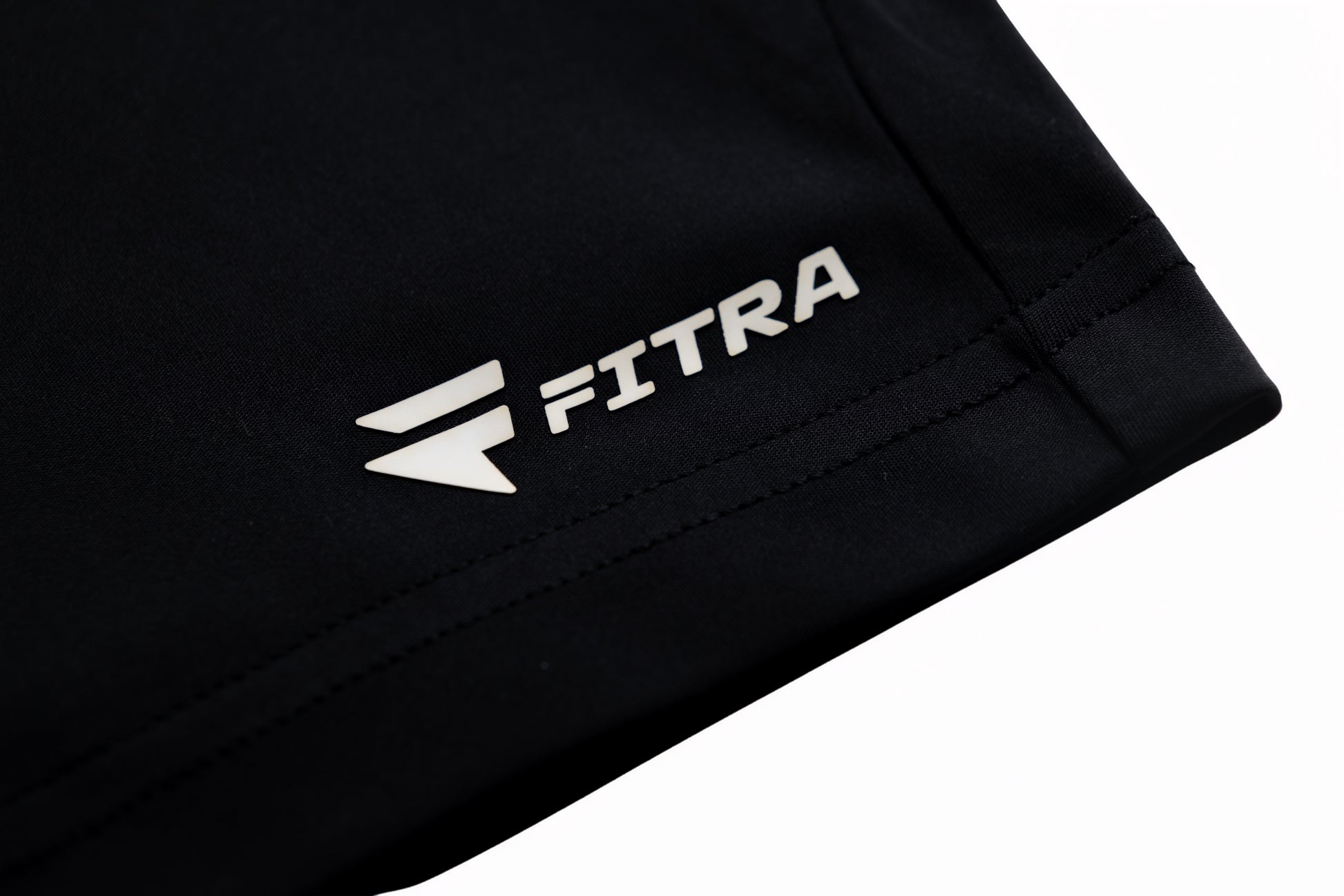 White Fitra logo printed on the hem of the black Core Short